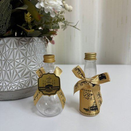 قناني ماء زمزم بلاستيك مع زينة ذهبي